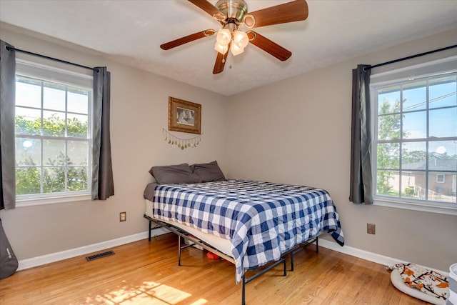 2013 Lamar Rd, Augusta, GA 30904 - bedroom featuring multiple windows, light wood-type flooring, and baseboards