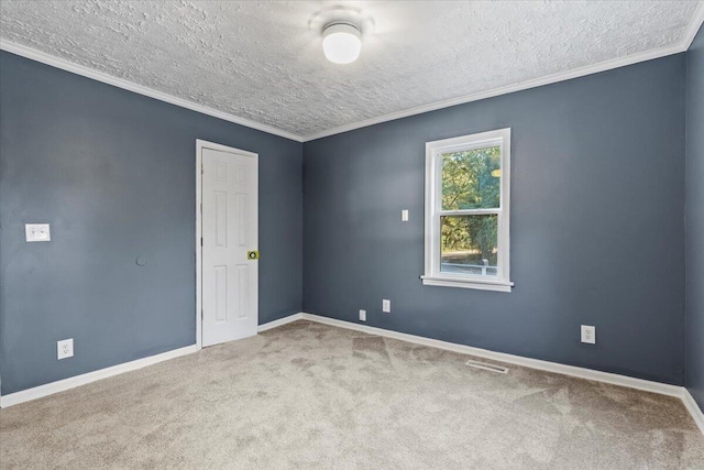 empty room with crown molding, light colored carpet, and a textured ceiling