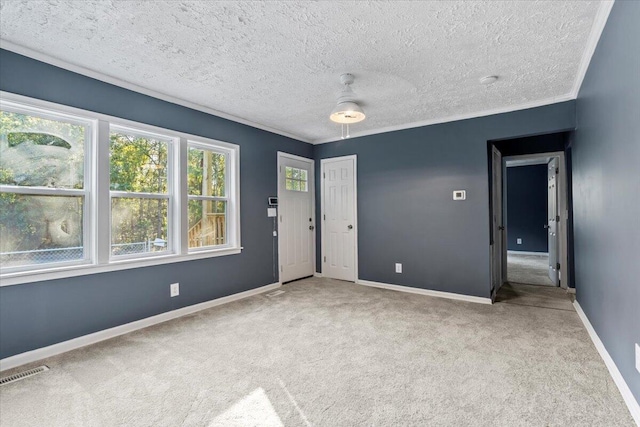 unfurnished room with ceiling fan, light colored carpet, and a textured ceiling