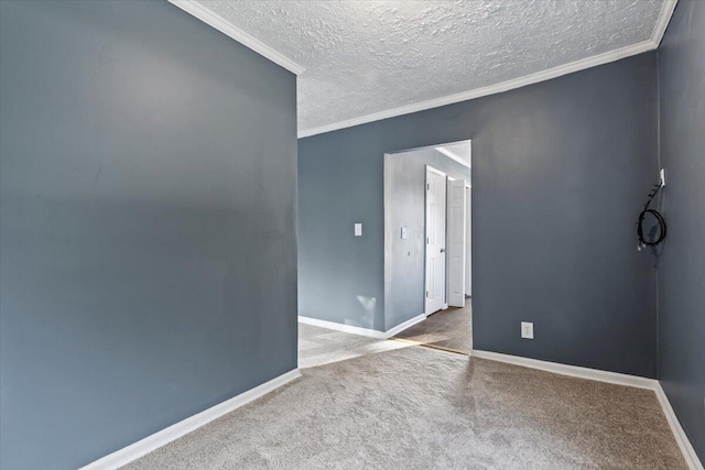 carpeted empty room with a textured ceiling and ornamental molding