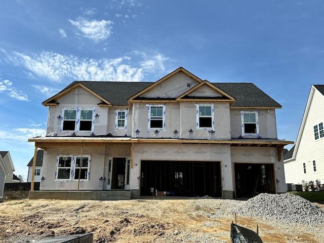 property under construction featuring a garage and central air condition unit