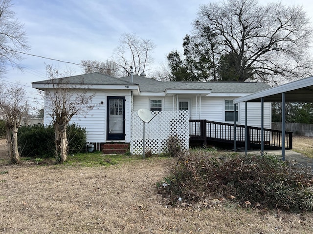 view of front of home featuring a deck and a carport