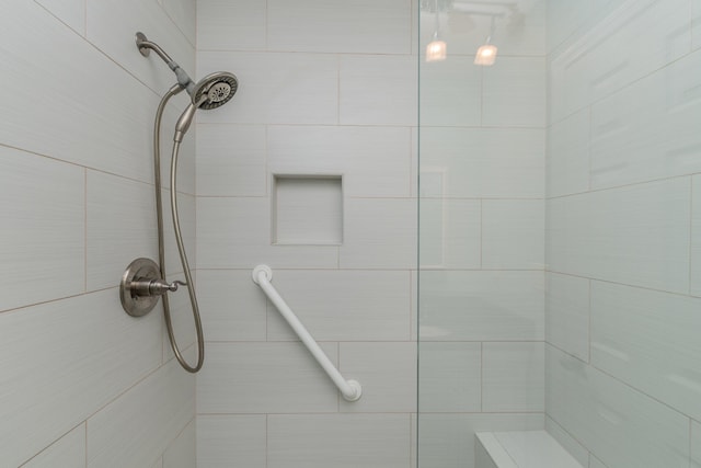 bathroom with a tile shower