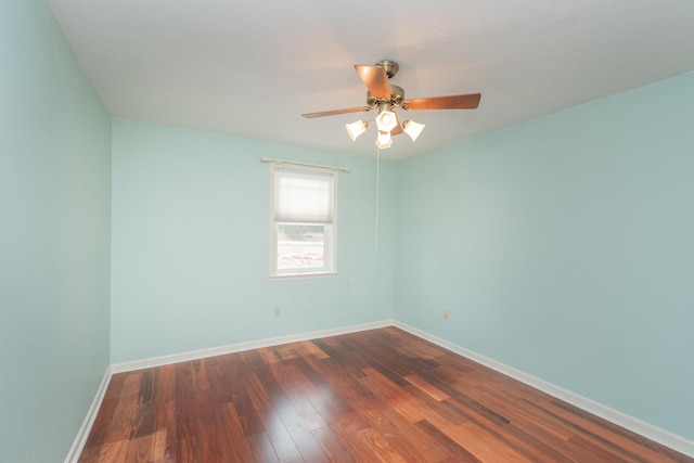 empty room featuring ceiling fan and dark hardwood / wood-style flooring