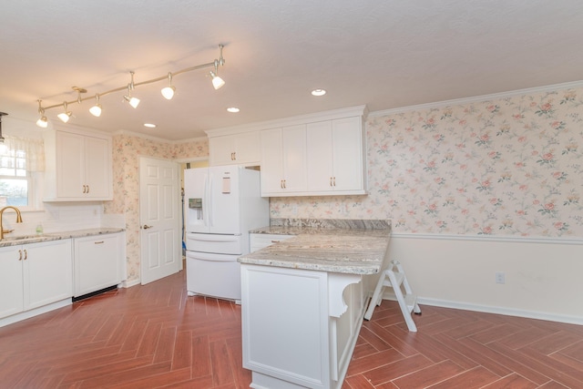 kitchen featuring white cabinetry, dark parquet flooring, white refrigerator with ice dispenser, and ornamental molding