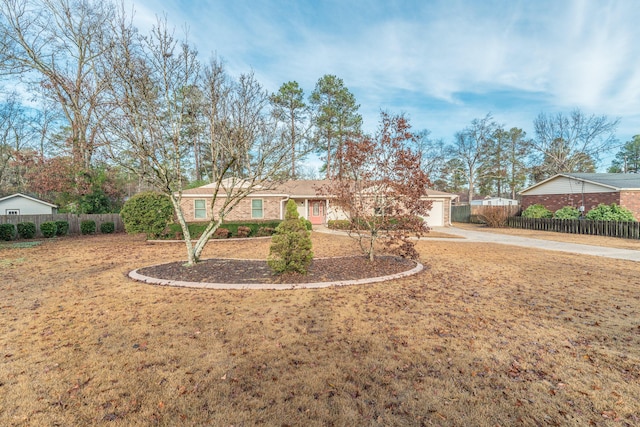 ranch-style home featuring a front lawn and a garage