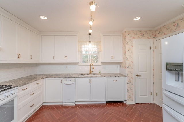 kitchen with white appliances, dark parquet floors, sink, white cabinetry, and hanging light fixtures