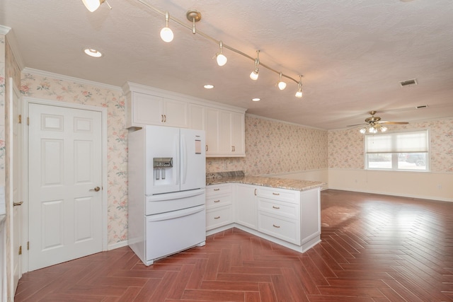 kitchen with white refrigerator with ice dispenser, dark parquet flooring, white cabinets, and crown molding