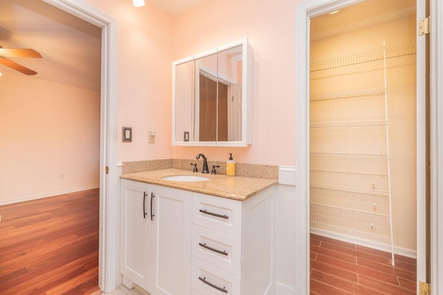 bathroom with ceiling fan and vanity