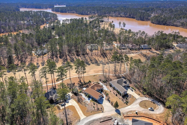 birds eye view of property with a water view and a forest view