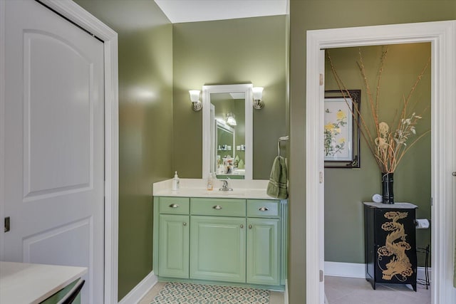 bathroom featuring tile patterned flooring, vanity, and baseboards