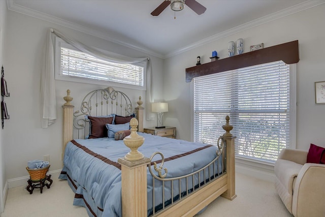 carpeted bedroom with ornamental molding, baseboards, and a ceiling fan