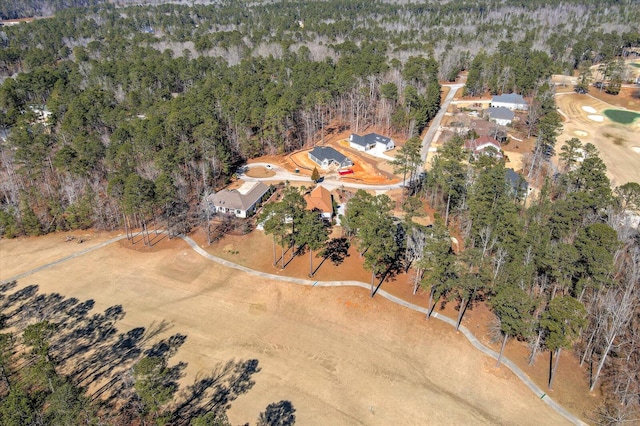 birds eye view of property with a forest view