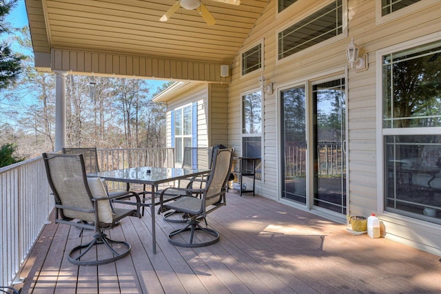 wooden deck featuring a ceiling fan and outdoor dining space