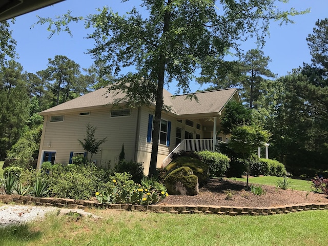 view of property exterior featuring covered porch