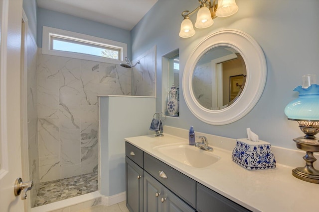 full bathroom featuring a marble finish shower and vanity