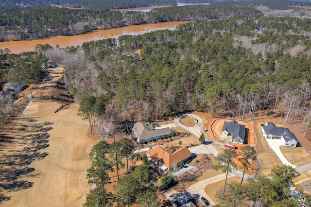 bird's eye view with a water view and a wooded view