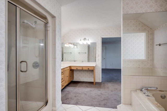 bathroom with lofted ceiling, a garden tub, vanity, a stall shower, and wallpapered walls