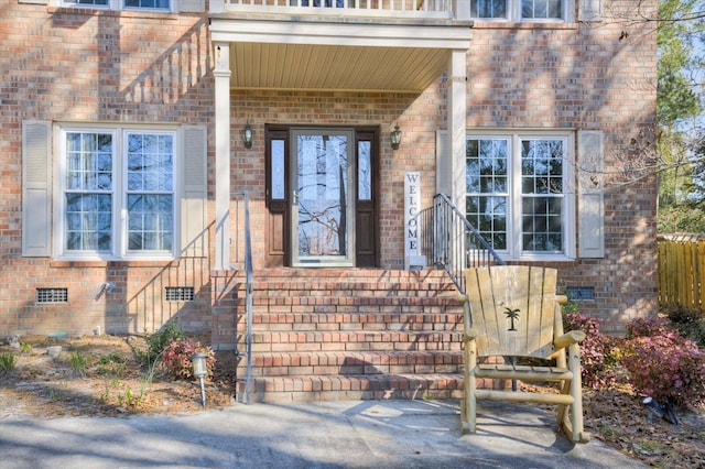 property entrance with crawl space and brick siding