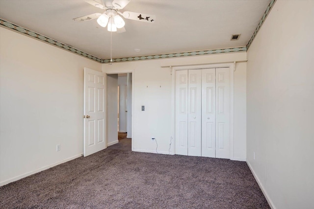 unfurnished bedroom featuring carpet floors, a closet, visible vents, ceiling fan, and baseboards