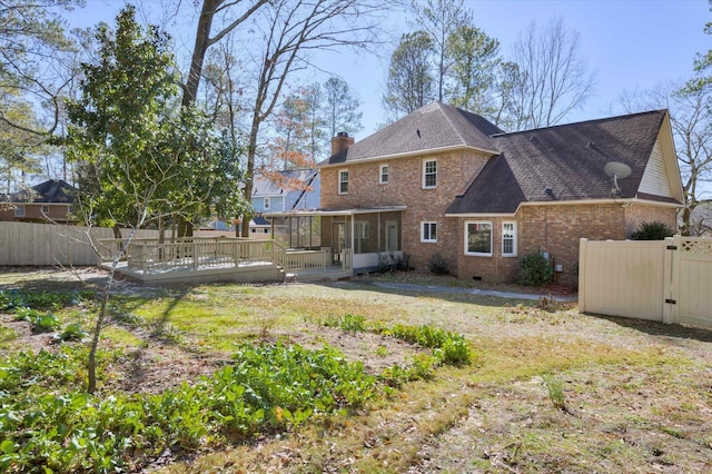 back of property featuring crawl space, a sunroom, a chimney, and fence