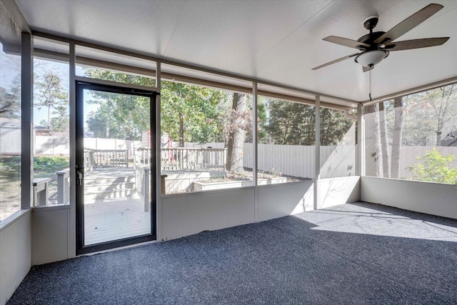 unfurnished sunroom featuring a wealth of natural light and ceiling fan