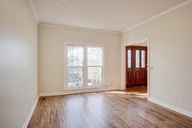 entryway featuring crown molding, baseboards, and wood finished floors