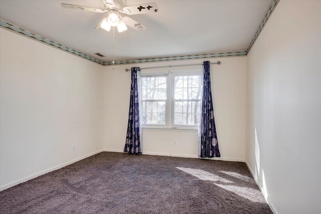 carpeted spare room featuring visible vents, ceiling fan, and baseboards