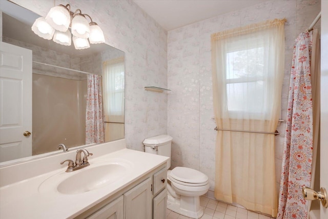 full bath featuring toilet, wallpapered walls, plenty of natural light, and vanity