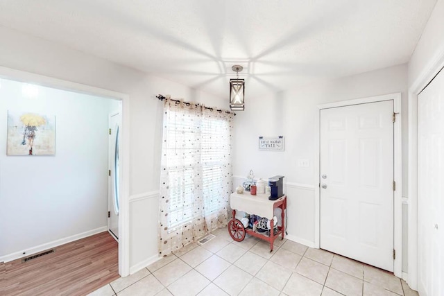 foyer entrance with light tile patterned flooring