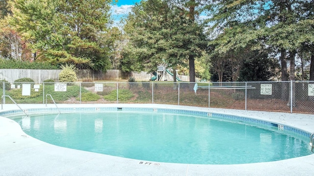 view of pool with a playground