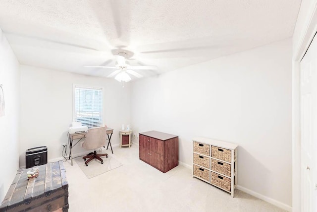 home office featuring light carpet and ceiling fan