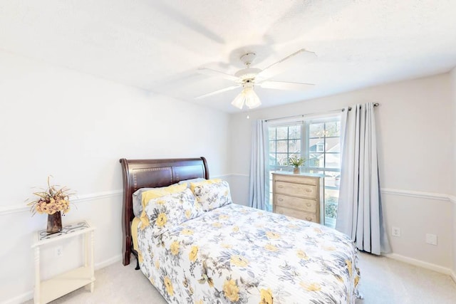 bedroom featuring ceiling fan and light carpet