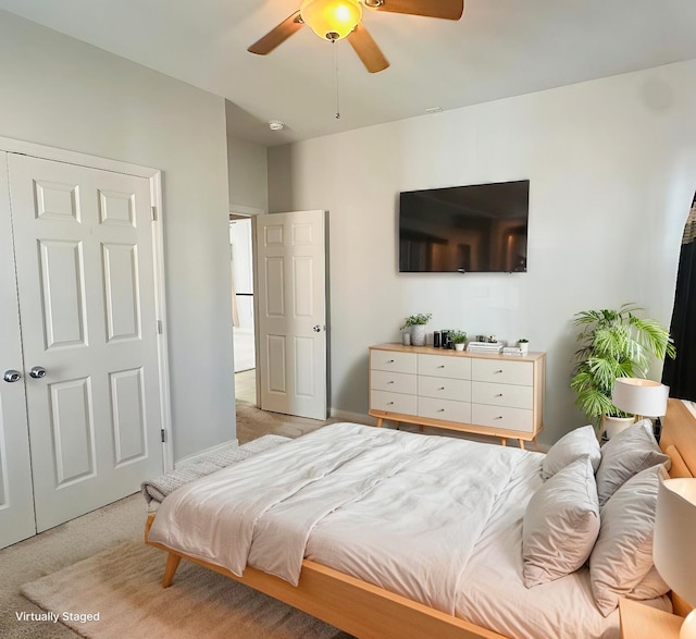 bedroom with light carpet, ceiling fan, and baseboards