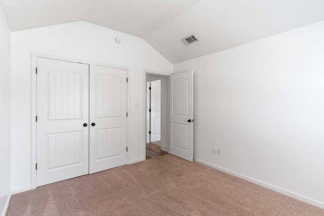 7058 Summerton Dr, Augusta, GA 30909 - unfurnished bedroom featuring carpet, baseboards, lofted ceiling, visible vents, and a closet