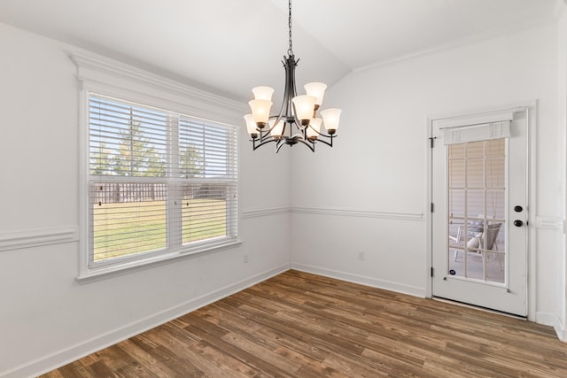 7058 Summerton Dr, Augusta, GA 30909 - unfurnished dining area with crown molding, vaulted ceiling, wood finished floors, baseboards, and a chandelier