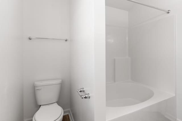 7058 Summerton Dr, Augusta, GA 30909 - bathroom with toilet, baseboards, a bathtub, and a shower