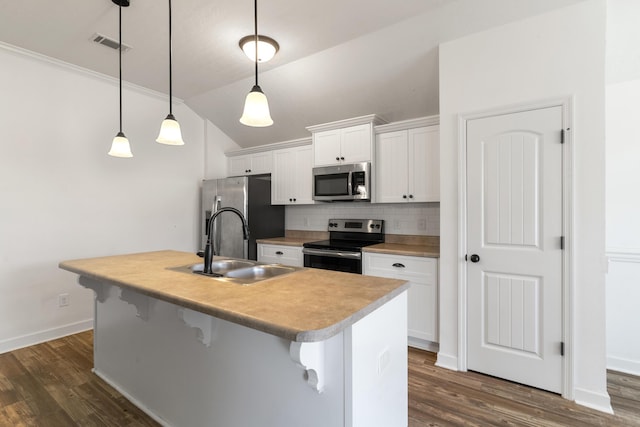 7058 Summerton Dr, Augusta, GA 30909 - kitchen with a breakfast bar area, visible vents, dark wood finished floors, a sink, and stainless steel appliances