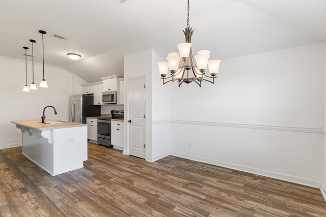 7058 Summerton Dr, Augusta, GA 30909 - kitchen featuring white cabinets, stainless steel appliances, baseboards, lofted ceiling, and dark wood-type flooring