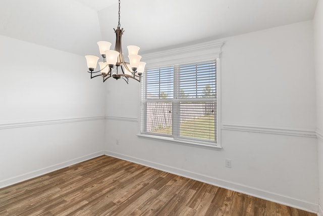 7058 Summerton Dr, Augusta, GA 30909 - unfurnished dining area with an inviting chandelier, baseboards, wood finished floors, and lofted ceiling