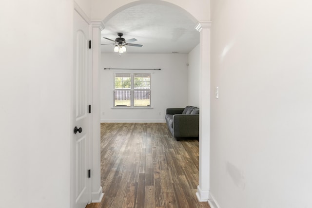 7058 Summerton Dr, Augusta, GA 30909 - hall with arched walkways, baseboards, ornate columns, and dark wood-type flooring