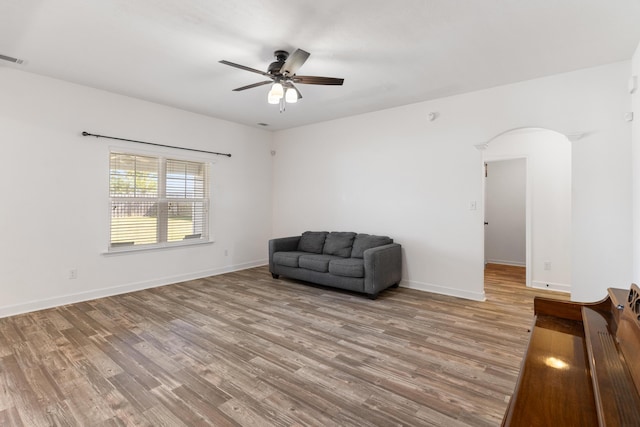 7058 Summerton Dr, Augusta, GA 30909 - sitting room with arched walkways, ceiling fan, baseboards, and wood finished floors
