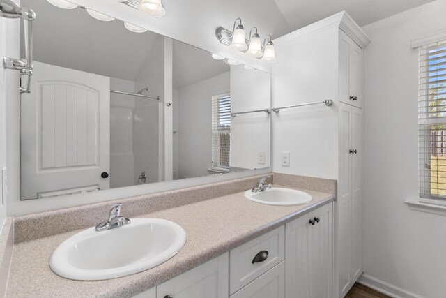 7058 Summerton Dr, Augusta, GA 30909 - full bathroom with double vanity, walk in shower, and a sink