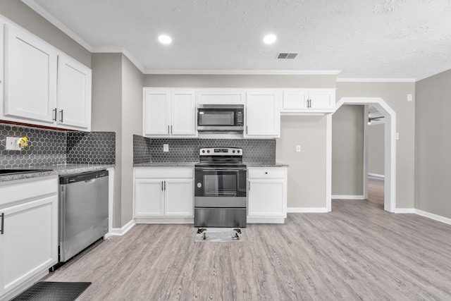 3808 Southfield Dr, Augusta, GA 30906 - kitchen featuring appliances with stainless steel finishes, light wood finished floors, crown molding, white cabinetry, and decorative backsplash