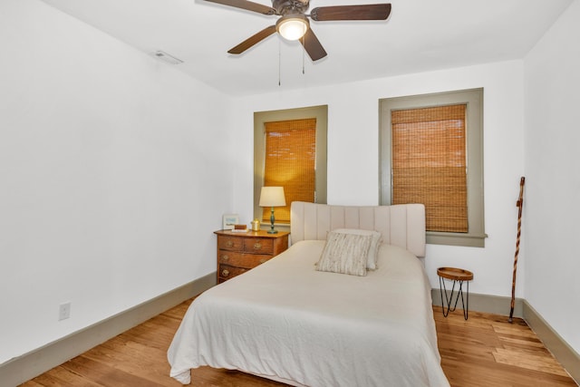 bedroom with ceiling fan and light hardwood / wood-style floors