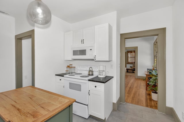 kitchen with white cabinetry, light tile patterned floors, white appliances, and decorative light fixtures