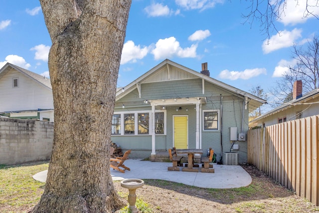 view of front of house with a patio and central air condition unit