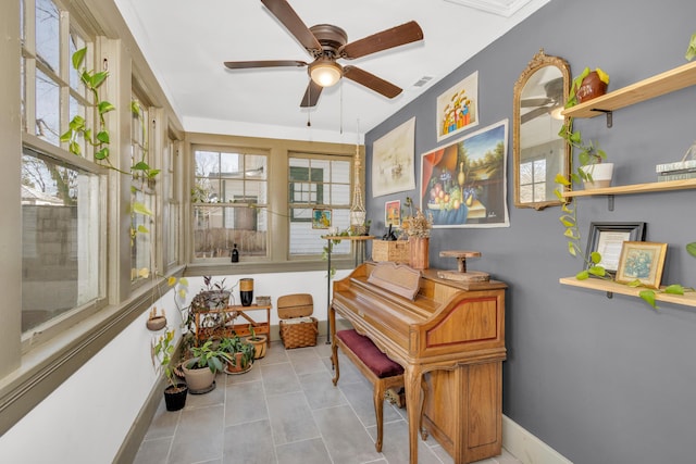 miscellaneous room featuring light tile patterned flooring and ceiling fan