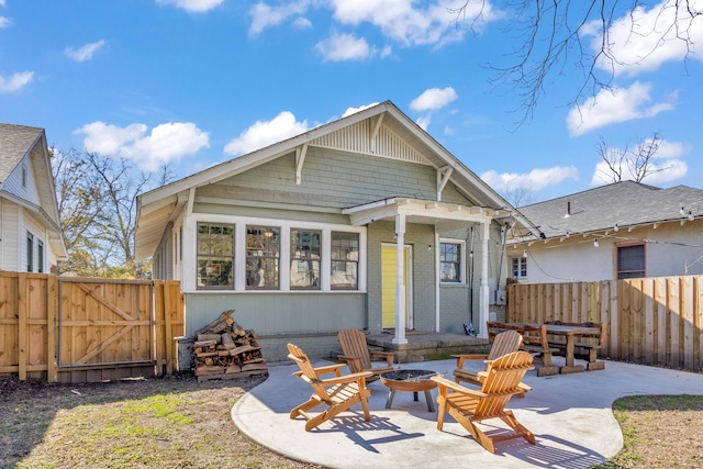 rear view of house featuring a patio area and an outdoor fire pit