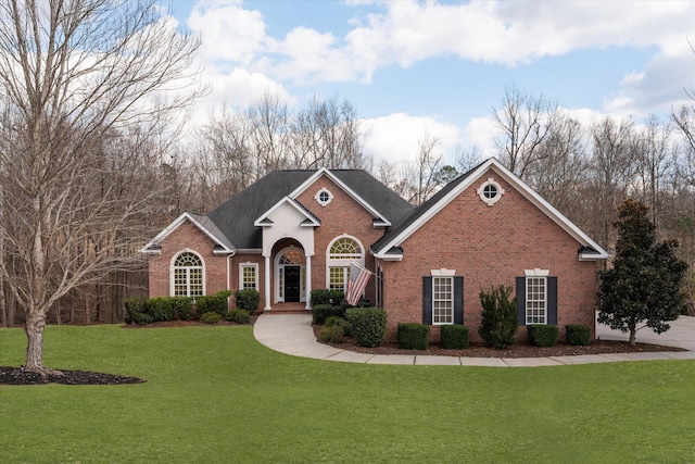 traditional-style house featuring brick siding and a front yard